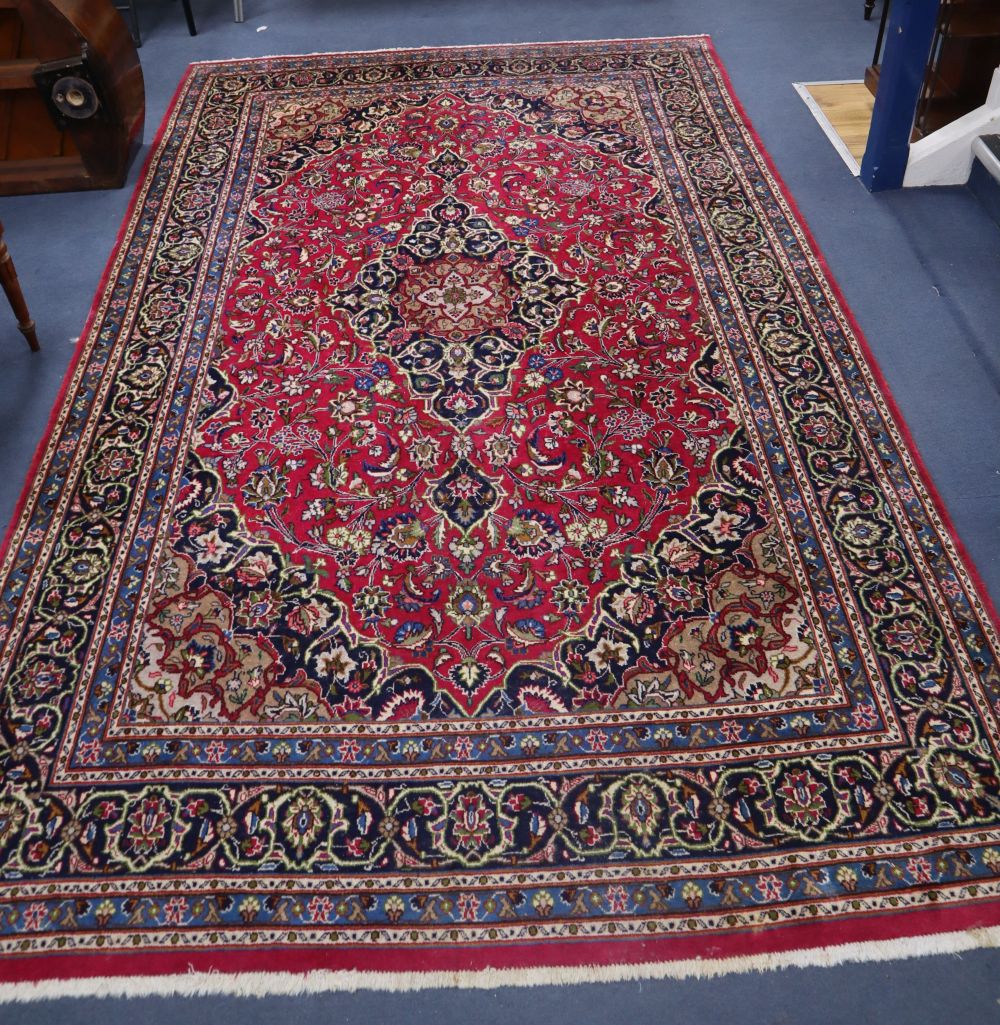 A Tabriz style burgundy ground carpet, 310 x 196cm